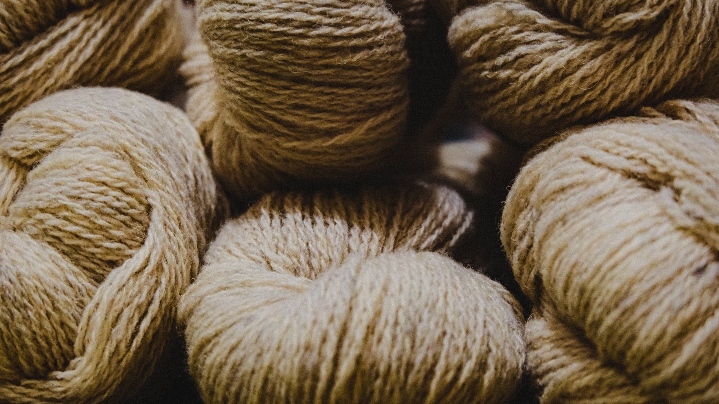 Skeins of natural brown and beige yarn texture.